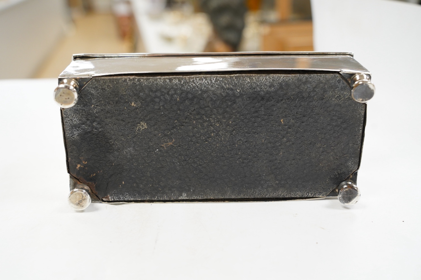 A George V engine turned silver cigarette box, by Padgett & Braham Ltd, London, 1935, 21.6cm and an earlier Irish silver cigarette box. Condition - poor to fair